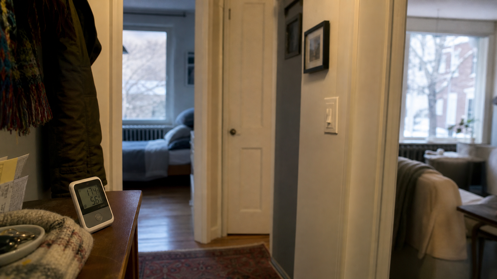 Hallway walk-through with doors and thermometer in older home